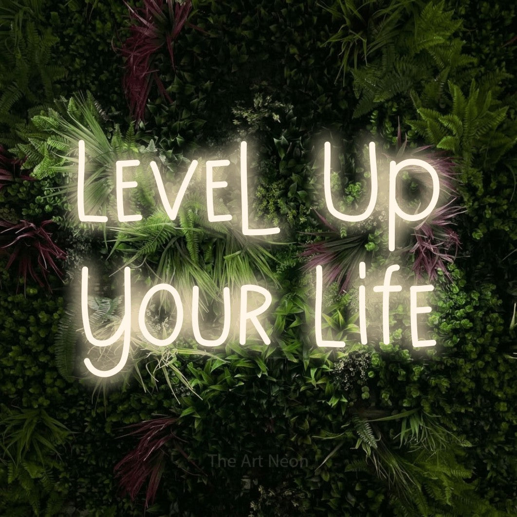 LED neon sign displaying “Level Up Your Life”.