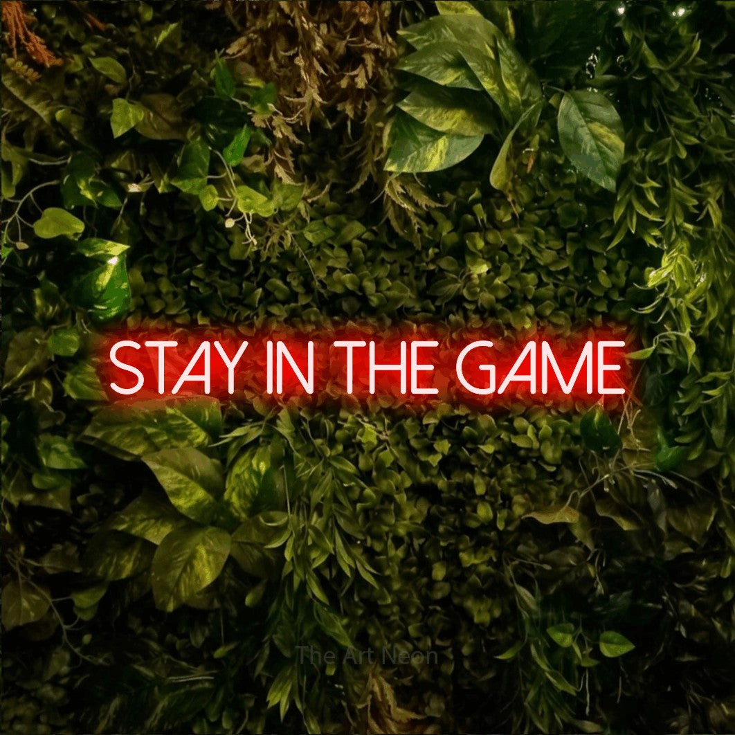 LED neon sign reading “Stay in the Game”, arranged in a single line.