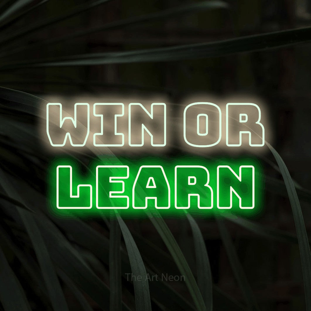 LED neon sign reading “win or learn”, arranged in 2 lines.