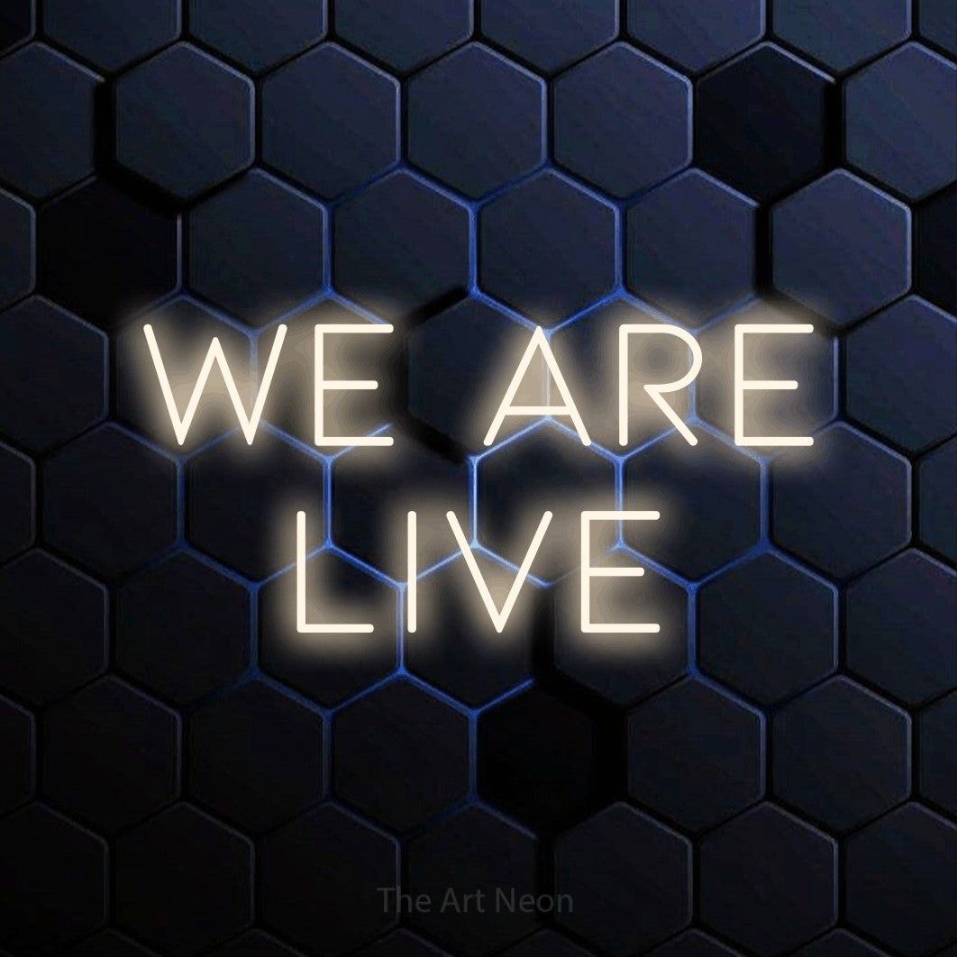 LED neon sign reading “We are Live”, arranged in 2 lines.