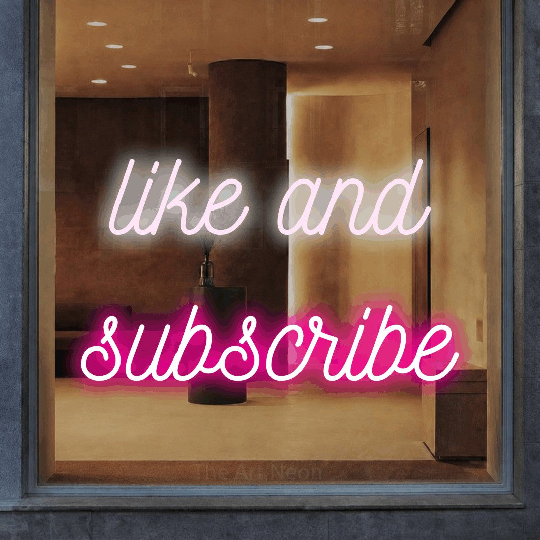 LED neon sign reading “like and subscribe”, arranged in 2 lines.