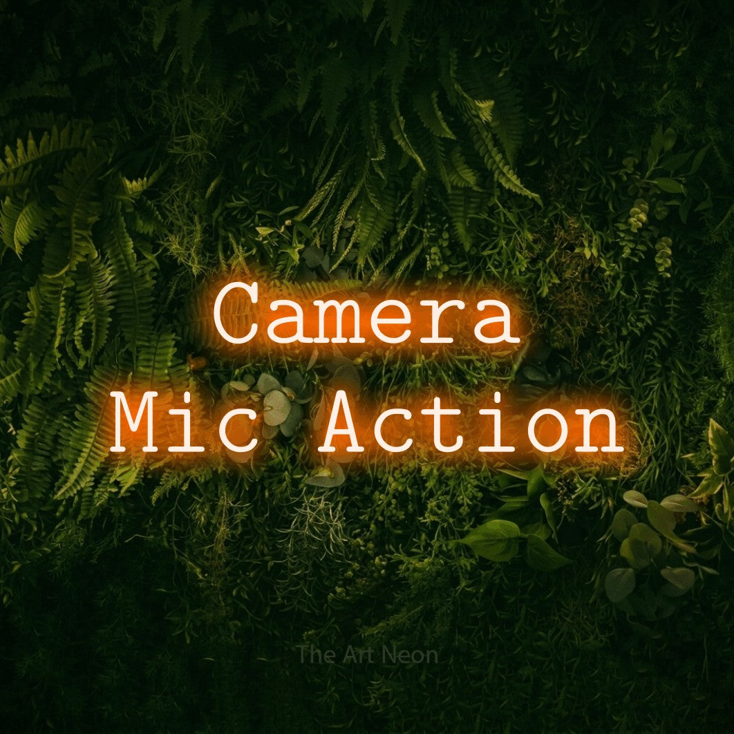 LED neon sign reading “Camera Mic Action”, arranged in 2 lines.