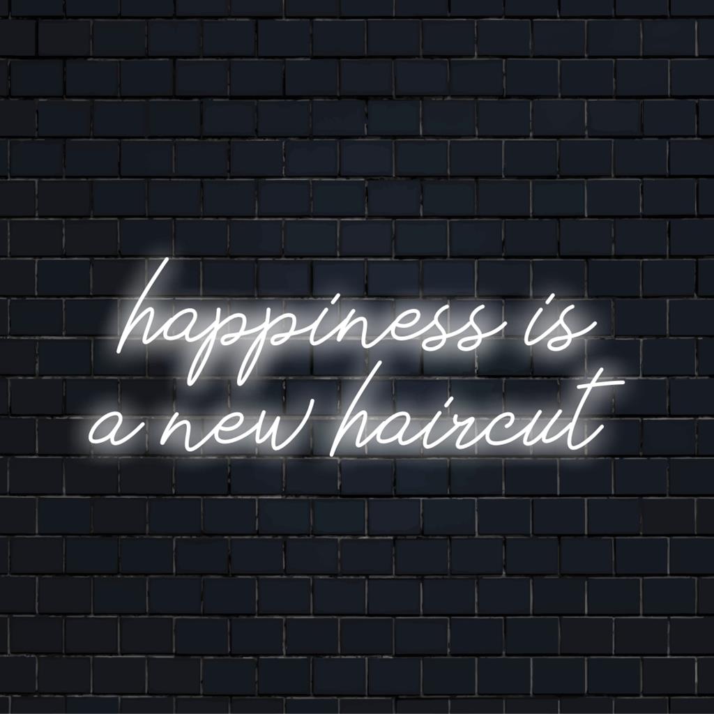 Bright, stylish custom LED neon sign stating Happiness Is A New Haircut, perfect for modern interior decor.