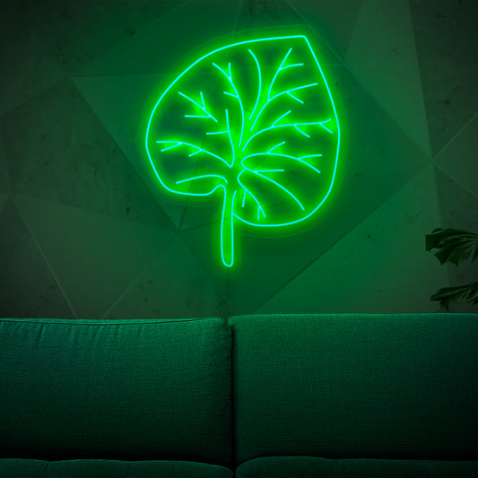 An illuminated neon sign featuring a vibrant green leaf, adding a touch of nature-inspired beauty and organic charm to any space