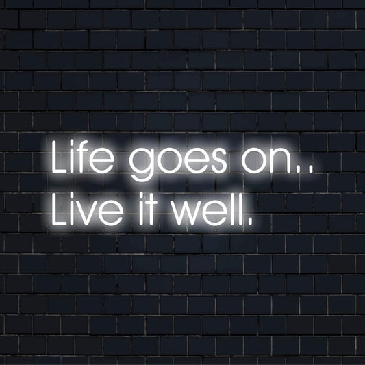 Life Goes On.. Live It Well LED sign illuminates with vibrant colors; a motivational neon quote art piece for any space.