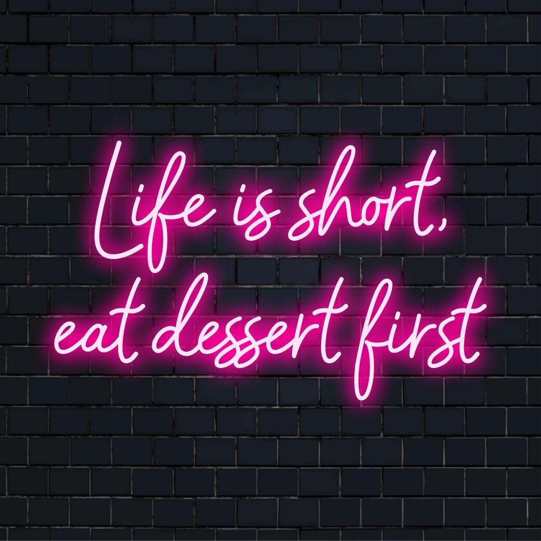 Custom LED neon sign displaying the phrase Life Is Short, Eat Dessert First in stylish neon decor.