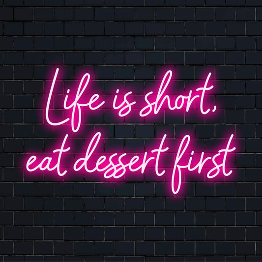 Custom LED neon sign displaying the phrase Life Is Short, Eat Dessert First in stylish neon decor.