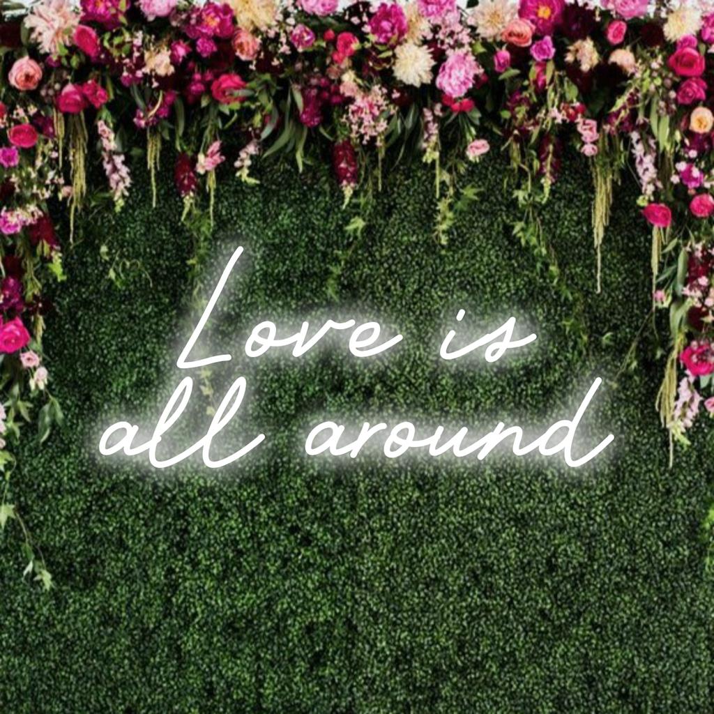 LED neon sign displaying Love Is All Around in vibrant colors, ideal for adding warmth and positivity to any space.