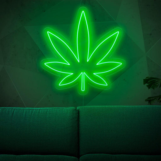 An illuminated neon sign featuring a marijuana leaf, symbolizing cannabis and weed culture, adding a touch of herbal charm to any space