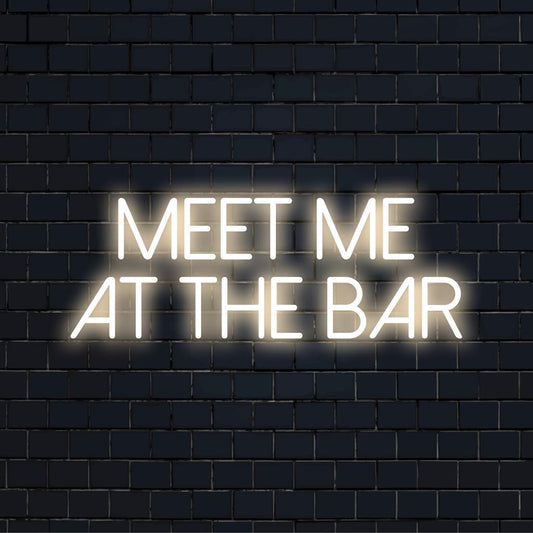 Custom LED neon sign spelling out Meet Me At The Bar, ideal for home bar decor or venues. Vibrant neon light display.
