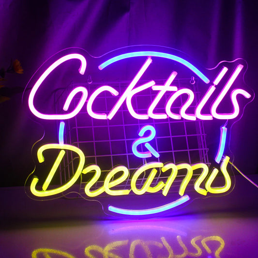 The image showcases a vibrant, handmade LED neon sign depicting the words "Cocktails Dreams.