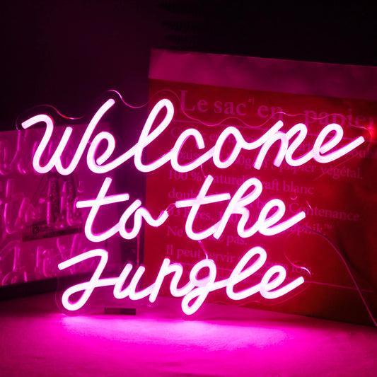 A vibrant LED neon sign displaying the words "Welcome to the Jungle" in a bold, playful script.