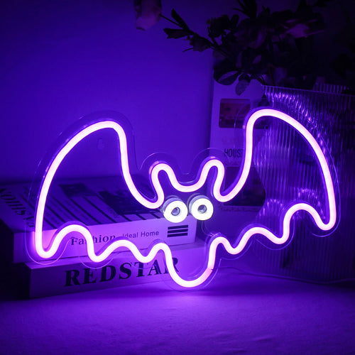 Das Bild zeigt ein leuchtendes, handgefertigtes LED-Neonschild in Form einer Fledermaus.