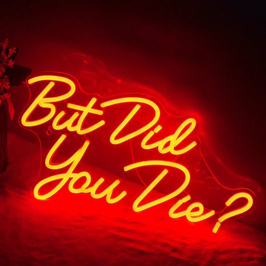 The image features a vibrant LED neon sign displaying the phrase "But did you die" in bold, playful lettering.