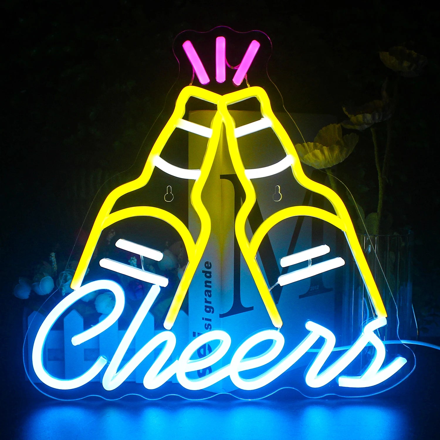 A vibrant LED neon sign displaying the word "Cheers" in cursive script.