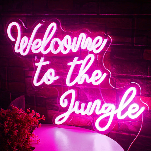 The image features a vibrant "Welcome to the Jungle" LED neon sign in bold, cursive lettering.