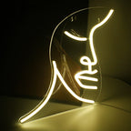 Ein lebendiges, handgefertigtes LED-Neonschild mit einer stilisierten Illustration eines Gesichts.