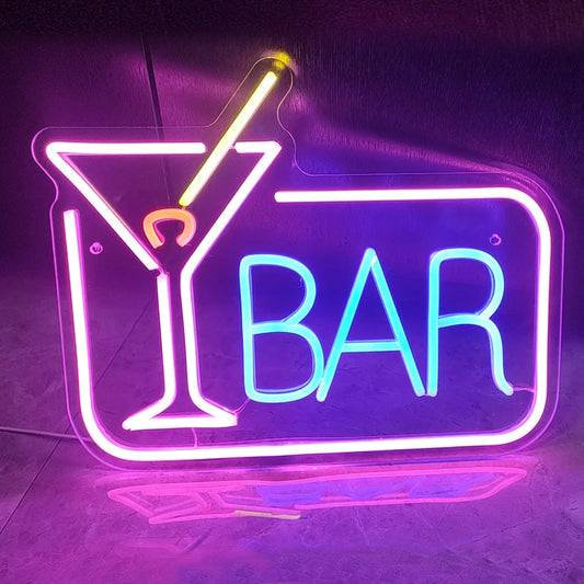 A vibrant LED neon sign displaying the words "Cocktails Bar" in a stylish cursive font.