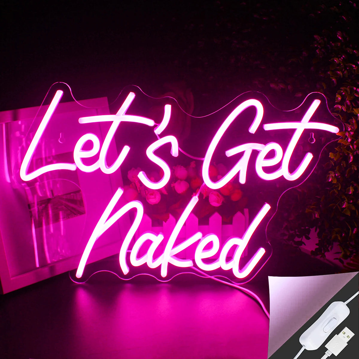The image features a vibrant LED neon sign displaying the phrase "Let's Get Naked" in a stylish script font.
