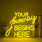 "A handcrafted LED neon sign displaying the words 'Journey Begin' in a flowing script font.