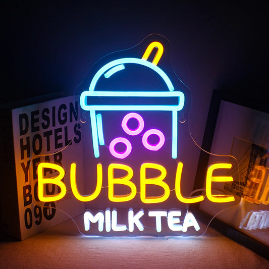 The image displays a vibrant LED neon sign in the shape of a bubble milk tea cup.
