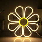 Das Bild zeigt ein leuchtendes LED-Neonschild in Form einer Blume.