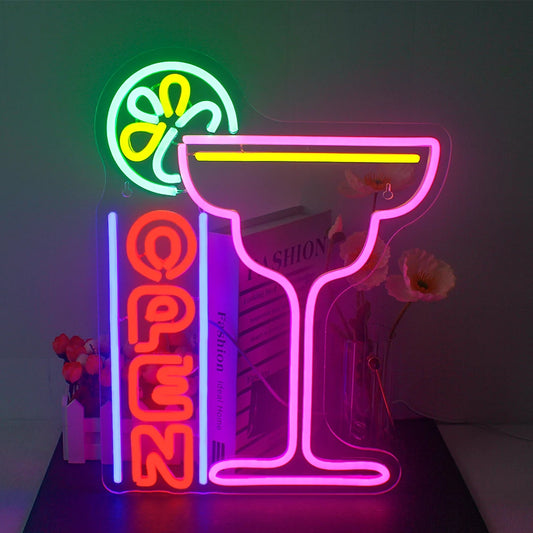 A vibrant LED neon sign displaying the words "Cocktails Open" in an alluring script font.