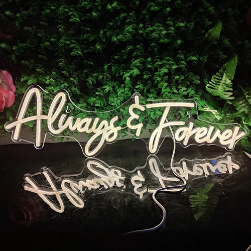 Das Bild zeigt ein leuchtendes LED-Neonschild mit den Worten „Always Forever“ in eleganter Schreibschrift.