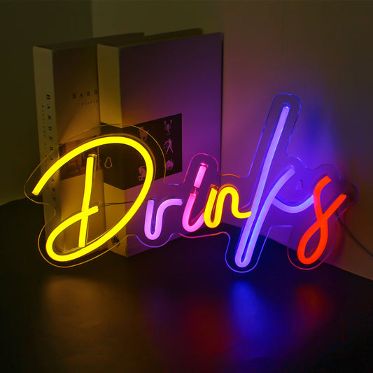 The image features a vibrant LED neon sign displaying a colorful assortment of drink-related shapes and symbols.