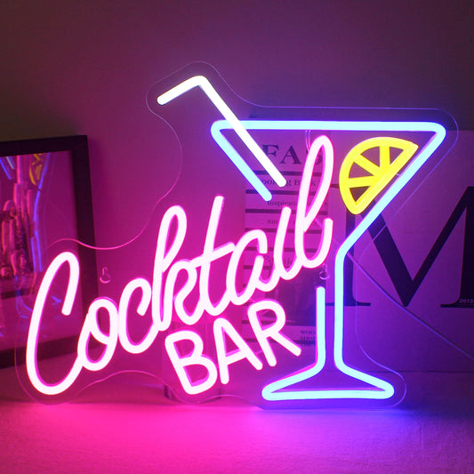 "A vibrant LED neon sign displaying the words 'Cocktail Bar' in a playful, cursive font.