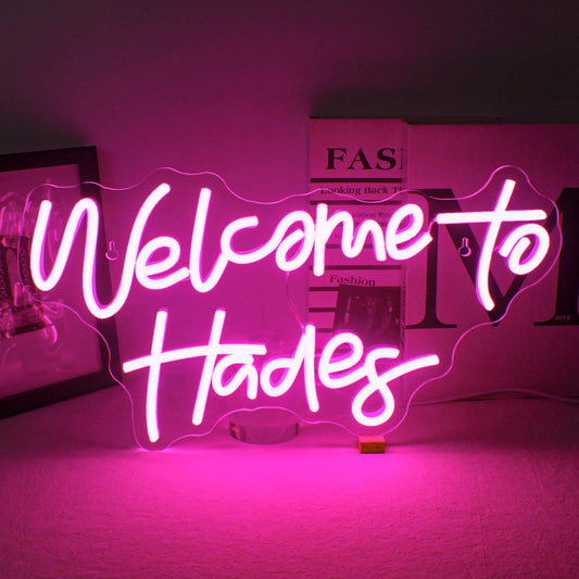 An LED neon sign spelling out the words "Welcome to Hades" in bright, glowing neon lights.