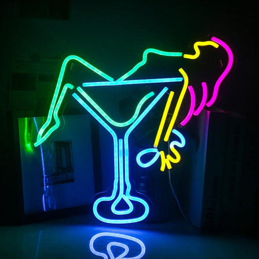 The image features a vibrant LED neon sign depicting a stylized artwork of a woman holding a wine glass.