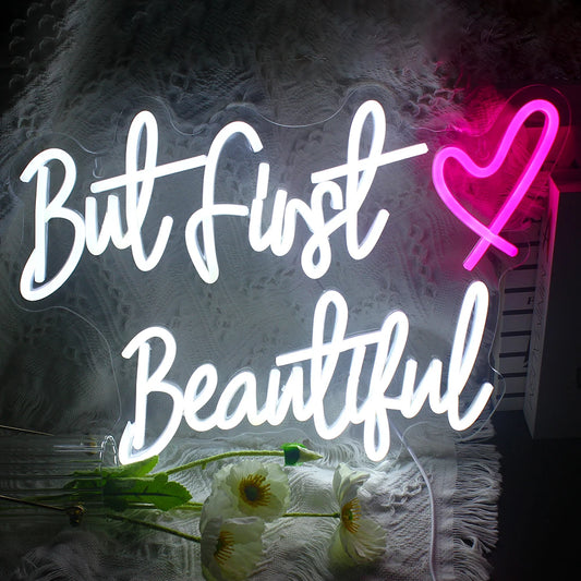 The image features a handmade LED neon sign displaying the phrase "But First".