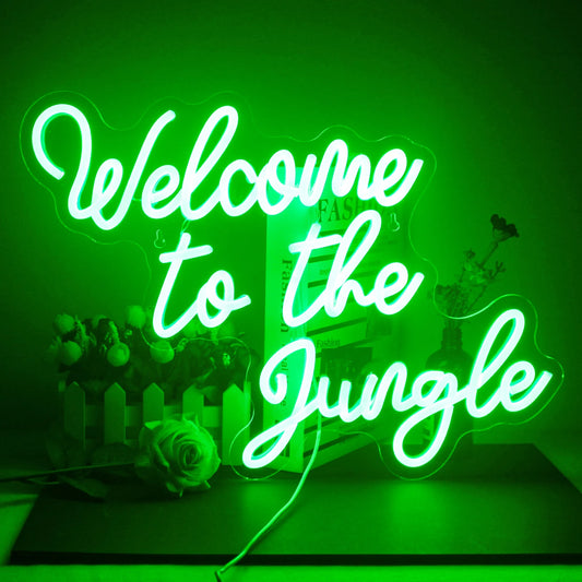 A vibrant LED neon sign that reads "Welcome To The Jungle" in bold, playful script.