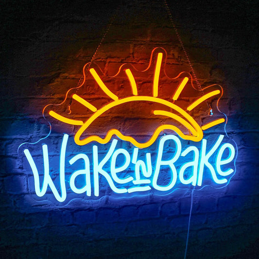 The image displays a vibrant, handmade LED neon sign featuring the playful text "Wake n' Bake" in stylish, cursive font.