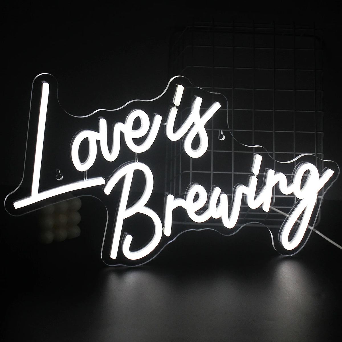 A vibrant LED neon sign displaying the phrase "Love is Breaking," featuring bold, modern typography.