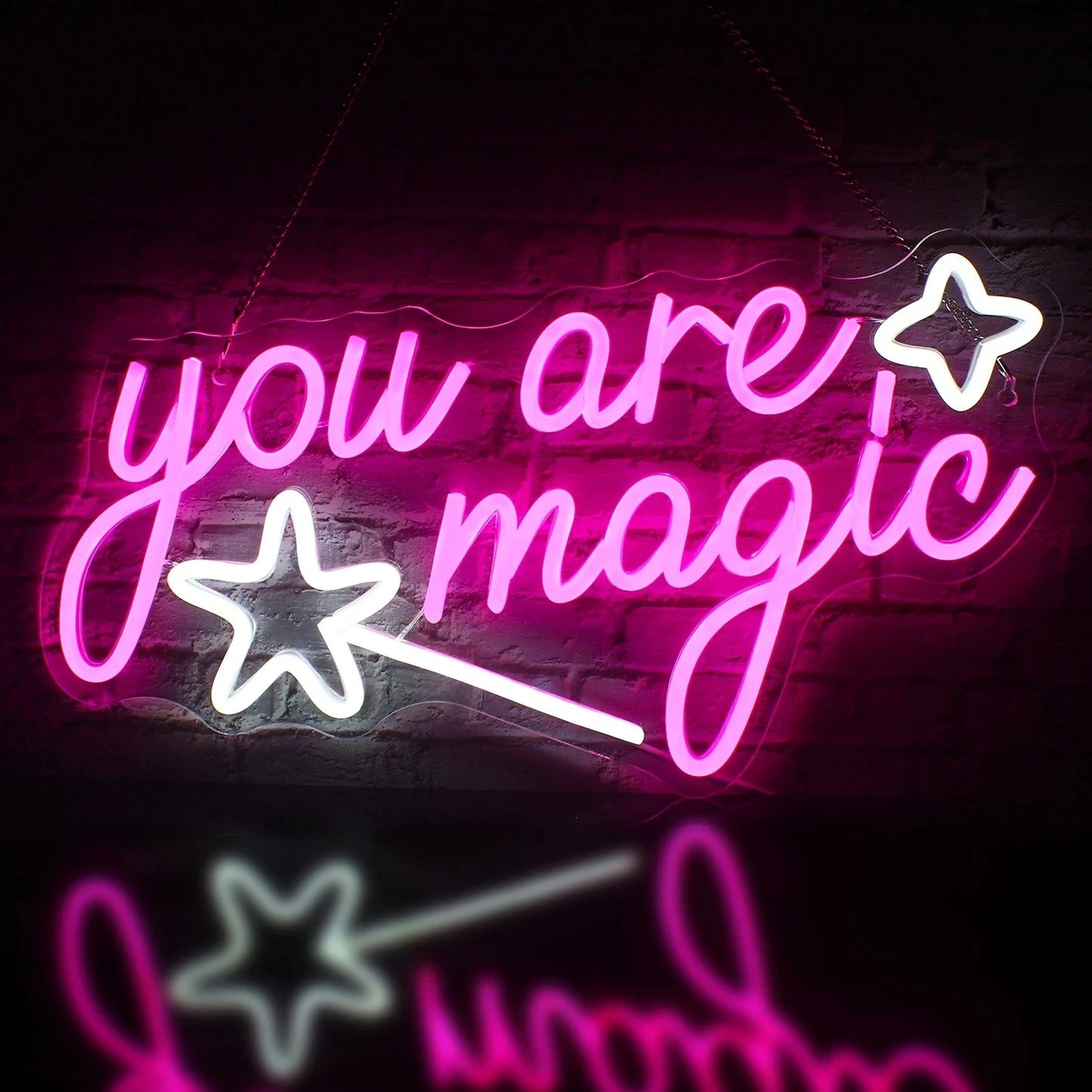 The image displays a vibrant LED neon sign that reads "You Are Magic" in flowing, cursive script.