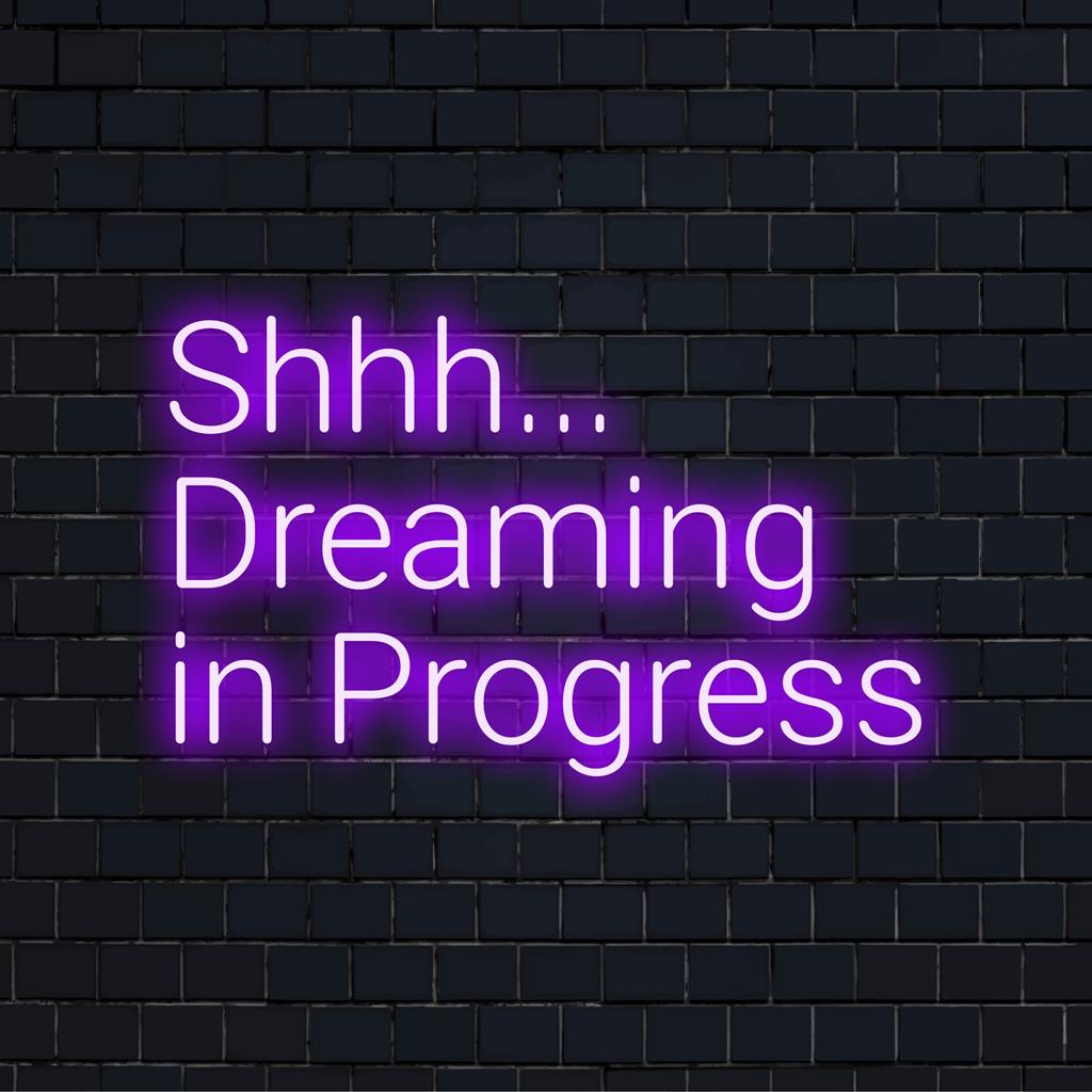 Custom LED neon sign displaying Shhh... Dreaming In Progress, perfect for unique neon light decor in any space.