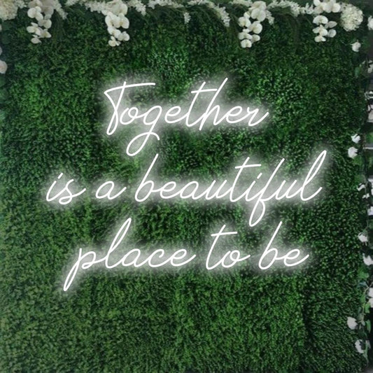 A custom made LED neon sign featuring the quote Together Is A Beautiful Place To Be glowing in vibrant hues, perfect for home decor.