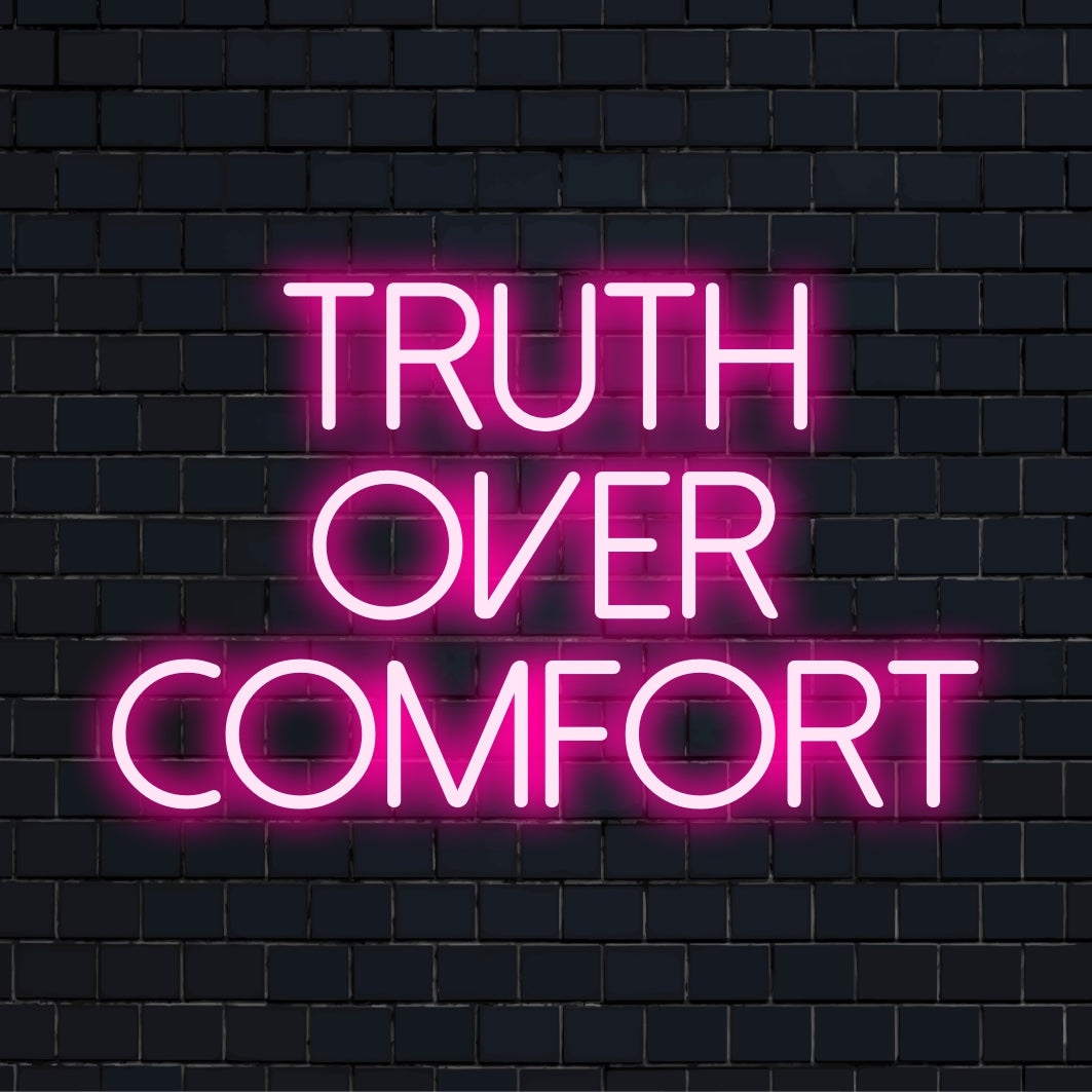LED neon sign with bold white text reading, Truth Over Comfort, showcasing minimalist and sleek neon light decor.