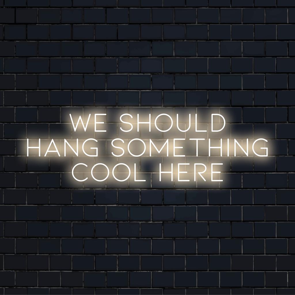 Custom-made LED neon sign with the phrase We Should Hang Something Cool Here, perfect for adding chic decor flair.