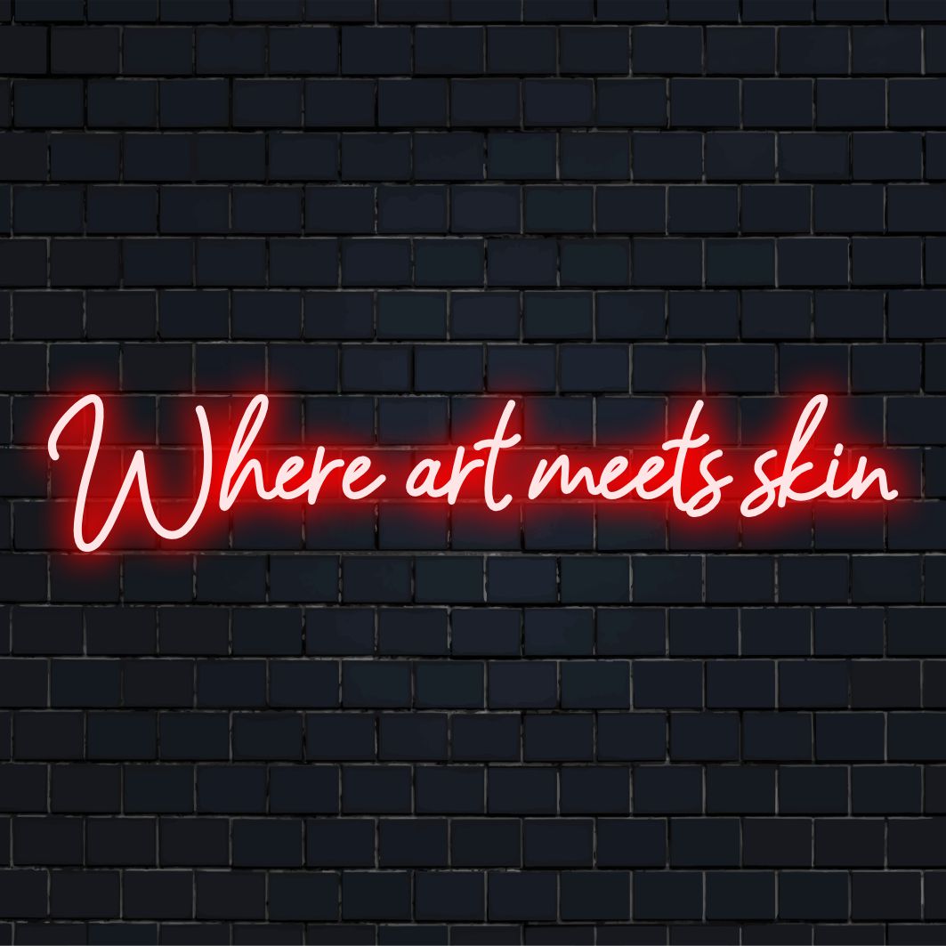 Vibrant LED neon sign reading Where Art Meets Skin – a custom masterpiece blending art with luminous decor.