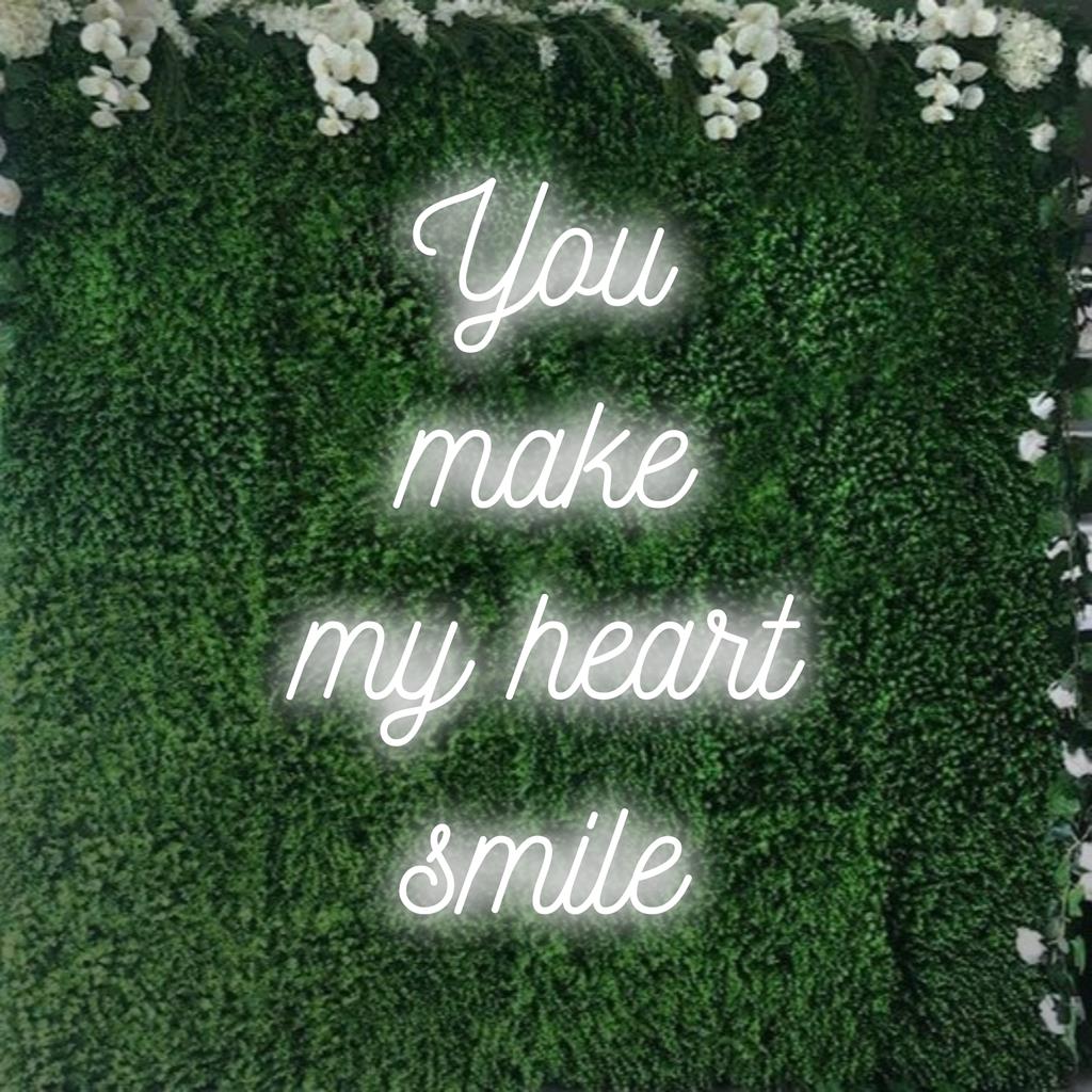 Radiant neon sign with 'You Make My Heart Smile' text, perfect for adding charm and warmth to any space. Custom LED design.