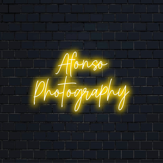 Afonso Photography Personalized LED Neon Sign, glowing neon text on black brick background