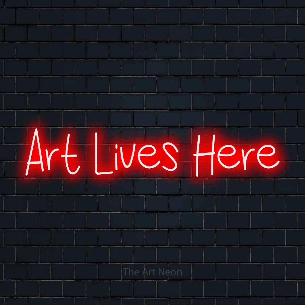 "Art Lives Here" glowing LED neon sign on a black brick wall