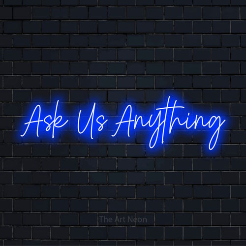 "Ask Us Anything" glowing LED neon sign on a black brick wall