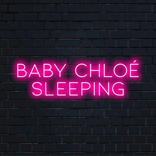 Baby Chloe Sleeping Personalized Neon Light with bright LED glow on dark brick wall