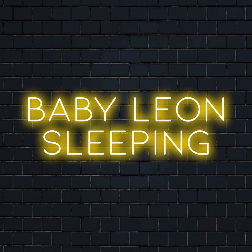 Baby Leon Sleeping Personalized LED Neon Sign, glowing neon text on dark brick wall