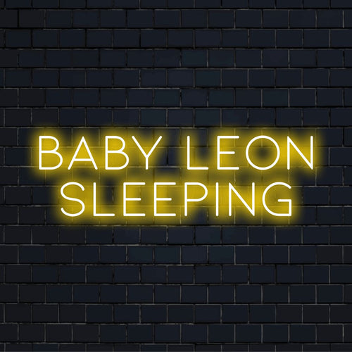 Baby Leon Sleeping Personalized LED Neon Sign, glowing neon text on dark brick wall