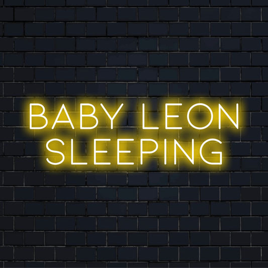 Baby Leon Sleeping Personalized LED Neon Sign, glowing neon text on dark brick wall